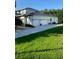 Spacious 3-car garage with ample parking on an extra-long driveway, complemented by lush green lawn at 177 Costa Loop, Auburndale, FL 33823