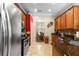 Stylish kitchen boasting stainless steel appliances, wood cabinets, granite countertops, and a view into the dining room at 177 Costa Loop, Auburndale, FL 33823