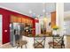 Modern kitchen featuring stainless steel appliances, granite countertops, bar seating, and sleek wooden cabinetry at 177 Costa Loop, Auburndale, FL 33823