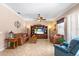 Spacious living room with stylish tile flooring, large entertainment center, ceiling fan, and cozy seating at 177 Costa Loop, Auburndale, FL 33823