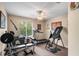 Brightly lit workout room featuring weights, a treadmill, an inversion table, and a ceiling fan at 177 Costa Loop, Auburndale, FL 33823