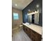 Bathroom featuring large vanity, stylish lighting, and shiplap accent wall at 1781 Lakehill Dr, Winter Haven, FL 33884