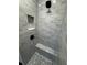 Bathroom shower featuring grey subway tile walls, a shower bench, and black hardware at 1781 Lakehill Dr, Winter Haven, FL 33884