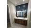 Modern bathroom featuring double vanity, stylish lighting, and shiplap accent wall at 1781 Lakehill Dr, Winter Haven, FL 33884