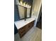 Bathroom featuring large vanity with dual drawers, stylish lighting, and shiplap accent wall at 1781 Lakehill Dr, Winter Haven, FL 33884