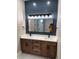 Bathroom featuring double vanity, stylish lighting, and shiplap accent wall at 1781 Lakehill Dr, Winter Haven, FL 33884