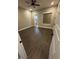 A bedroom featuring wood-look flooring, a ceiling fan, and an ensuite bathroom at 1781 Lakehill Dr, Winter Haven, FL 33884