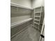 Walk-in closet with installed shelving, and closet rod, offers ample storage and organization solutions at 1781 Lakehill Dr, Winter Haven, FL 33884