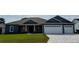 Charming single-story home with a brick facade, well-maintained lawn, and a two car garage with cobblestone driveway at 1781 Lakehill Dr, Winter Haven, FL 33884