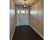 Warm and inviting foyer with dark wood floors, a white front door, and modern light fixture at 1781 Lakehill Dr, Winter Haven, FL 33884