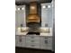 Elegant kitchen featuring white cabinets, granite countertops, a custom range hood, and tiled backsplash at 1781 Lakehill Dr, Winter Haven, FL 33884
