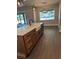 Modern kitchen island with white countertop and farmhouse sink, complemented by pendant lighting at 1781 Lakehill Dr, Winter Haven, FL 33884