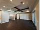 Open-concept living room with dark wood floors, tray ceiling, wood beams, and sliding glass doors at 1781 Lakehill Dr, Winter Haven, FL 33884
