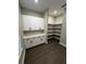 Pantry with white cabinets, counter space, and shelving, ideal for kitchen storage and organization at 1781 Lakehill Dr, Winter Haven, FL 33884