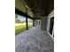 The covered patio features stone pavers and a wood plank ceiling with a ceiling fan at 1781 Lakehill Dr, Winter Haven, FL 33884