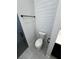 Bathroom showcasing shiplap wall detail, a toilet, and a glimpse into the shower with its patterned floor at 1787 Lakehill Dr, Winter Haven, FL 33884