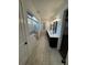 Bathroom featuring dual vanities, shiplap walls, a glass shower and modern light fixtures at 1787 Lakehill Dr, Winter Haven, FL 33884
