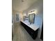 Bathroom featuring dual vanities, shiplap walls, and modern light fixtures at 1787 Lakehill Dr, Winter Haven, FL 33884