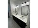 Bathroom features double sinks, modern mirrors and vanity lights at 1787 Lakehill Dr, Winter Haven, FL 33884