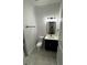 Well-lit bathroom with a modern vanity, shiplap accent wall, and a glimpse of the shower at 1787 Lakehill Dr, Winter Haven, FL 33884