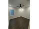A clean, unfurnished bedroom featuring dark wood floors and a modern ceiling fan at 1787 Lakehill Dr, Winter Haven, FL 33884