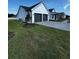 Side view of the home, showcasing the driveway and manicured landscaping at 1787 Lakehill Dr, Winter Haven, FL 33884