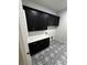 Bright laundry room featuring black shaker cabinets, white quartz countertops and patterned floor tiles at 1787 Lakehill Dr, Winter Haven, FL 33884