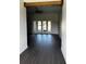 Bright living room featuring hardwood floors, a ceiling fan, and access to the backyard at 1787 Lakehill Dr, Winter Haven, FL 33884