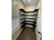Walk-in pantry with multiple levels of shelving and hardwood floors at 1787 Lakehill Dr, Winter Haven, FL 33884