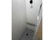 Modern shower featuring light gray vertical tiling, a black hexagonal tiled floor and a shower seat at 1787 Lakehill Dr, Winter Haven, FL 33884