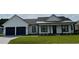 Charming single-story home featuring black trim, a manicured lawn and a two-car garage at 1787 Lakehill Dr, Winter Haven, FL 33884