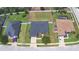 Expansive aerial view of a charming single-Gathering home boasting a large backyard and well-maintained landscaping at 186 Viola Dr, Auburndale, FL 33823