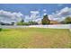 Expansive backyard enclosed by a white privacy fence and lush greenery at 186 Viola Dr, Auburndale, FL 33823