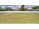 Large backyard featuring a white privacy fence, palm trees and manicured lawn at 186 Viola Dr, Auburndale, FL 33823