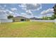 A spacious backyard featuring a well-maintained lawn and privacy fence at 186 Viola Dr, Auburndale, FL 33823