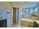 Relaxing bathroom with a soaking tub, separate shower, and decorative accents at 186 Viola Dr, Auburndale, FL 33823