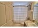 Clean bathroom featuring a vanity, toilet and shower with curtain at 186 Viola Dr, Auburndale, FL 33823