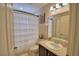 Bright bathroom featuring a vanity, mirror, and shower with curtain at 186 Viola Dr, Auburndale, FL 33823
