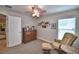 Bedroom with chair, carpet flooring, and shelf with decorations on the walls at 186 Viola Dr, Auburndale, FL 33823