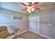 Bedroom with chair, carpet flooring, and closet with decorations on the walls at 186 Viola Dr, Auburndale, FL 33823