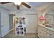 Bedroom featuring closet, doorway, ceiling fan, carpet flooring and white furnishings at 186 Viola Dr, Auburndale, FL 33823