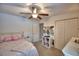 Bedroom featuring a ceiling fan, closet, and door leading to the hallway at 186 Viola Dr, Auburndale, FL 33823