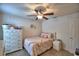 Comfortable bedroom with carpet flooring, a ceiling fan, and white furnishings at 186 Viola Dr, Auburndale, FL 33823