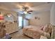 Bright bedroom with a ceiling fan, carpet flooring, and natural light from the window at 186 Viola Dr, Auburndale, FL 33823