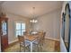 Charming dining room with wood table, chandelier, and shuttered windows at 186 Viola Dr, Auburndale, FL 33823