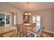 Dining room featuring wood table, chandelier, and access to office with sliding doors at 186 Viola Dr, Auburndale, FL 33823