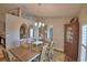 Cozy dining room with natural light, chandelier, and decorative mirrors at 186 Viola Dr, Auburndale, FL 33823