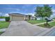 Charming single-story home featuring a manicured lawn, stone accents, and a two-car garage at 186 Viola Dr, Auburndale, FL 33823