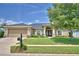 Charming single-story home featuring a manicured lawn, stone accents, and a two-car garage at 186 Viola Dr, Auburndale, FL 33823