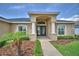 Home's front entrance showcasing stone pillars and double doors at 186 Viola Dr, Auburndale, FL 33823